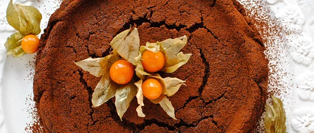 woman holding a birthday cake in a kitchen