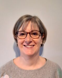 middle aged woman smiling for a camera selfie